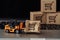 Orange forklift model and broken carton box on a keyboard close-up. Courier service and shipment accident concept