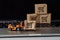 Orange forklift model and broken carton box on a keyboard. Courier service and shipment accident concept