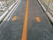 Orange Forward and Backward Traffic Arrows with Long Dividing Line on Overpass Floor