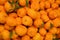 Orange fruit display at farmers market background