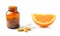 Orange fruit with vitamin c tablet on white background