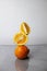 orange fruits citrus oranges flying falling arugula orange on a gray background. Creative shooting. vitamins citrus