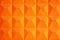 Orange geometric background. Fragment of reinforced concrete fence.