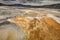 Orange geothermal pools, mountains and dark clouds, Yellowstone