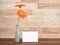 Orange Gerbera flower in vessel and blank notebook 1