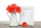 Orange gerbera flowers and photo frame on wooden table