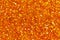 Orange glittering foil leaf shiny wrapping paper glitter texture background for Christmas holiday.