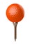 Orange golf ball on tee