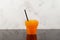 Orange Granizado in disposable plastic cup. Side view. Refreshing Slushie drink. Iced drink. Sweet citrus Shaved ice