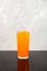 Orange Granizado in tall glass. Refreshing Slushie drink. Summer ice drink. Sweet citrus Shaved ice. Vertical orientation, copy