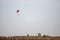 orange and Green parachute, made for two persons, a beginner and an instructor, falling fro the sky during a parachuting skydiving