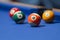 Orange, green, yellow and red billiard balls in a pool table