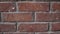 Orange grunge old bricks headers and stretchers close-up slow-tilt 4K UltraHD footage - house wall texture details