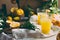 ORANGE. Haervest concept. Orange juice, full box of orange fruits ant orange tree branches on table with linen