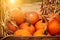 Orange halloween pumpkins on stack of hay or straw in sunny day, fall display