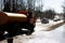 Orange harvesting machine and worker washes road in spring. Reportage. Gatchina. Russia