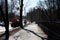 Orange harvesting machine and worker washes road in spring. Reportage. Gatchina. Russia