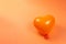 Orange heart ballon on orange background