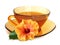 Orange hibiscus flower and tea in atransparent amber tea cup