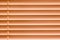 Orange horizontal blinds on the window create a rhythm_