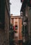 An orange house with windows next to a white house from which a rope hangs on which clothes are dried. Views of Croatia