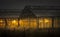 Orange illuminated nursery houses at night