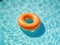 Orange inflatable ring floating in a pool