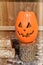 Orange Jack O Lantern Sitting On A Log