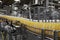 Orange juice bottles on conveyor in bottling plant