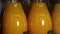 Orange juice in glass bottles, close-up