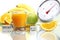 Orange juice in glass, fruit meter scales diet food