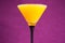 Orange juice in a martini glass on a violet background