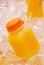 Orange Juice in Plastic Bottle on Ice Cubes