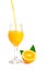 Orange juice pouring into glass with orange slice and leaf