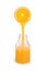 Orange juice pouring from orange slice in bottle