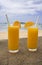 Orange juice in transparent glasses and a milkshake