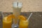 Orange juice in transparent glasses and a milkshake