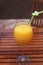 Orange juice in a wide glass with drinking straw