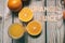 Orange juice wooden letters with many oranges fruit surrounding and orange juice on a drinking glass on a wooden board