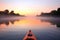 orange kayak on tranquil river at dawn