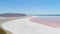 Orange lake in Crimea. Shot. Top view of bright orange lake water against white sand. Extraterrestrial landscape of