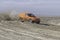 Orange land rover car on the beach