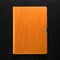 Orange leather book on dark background. Front view of hardcover book