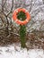 orange life buoy lake safety rope on stump outside in snow winter
