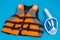 Orange life jacket and full face mask for diving, concept of diving and saving life in water