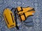 An orange life jacket, gray small rubber flippers, and an orange plastic rescue torpedo buoy for the lifeguard on the