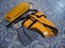 An orange life jacket, gray small rubber flippers, and an orange plastic rescue torpedo buoy for the lifeguard on the