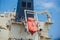 Orange lifeboat at tail of international cargo ship in the ocean for emergency evacuation loading for safety