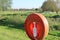 An orange lifebouy by the banks of the River Parrett in Langport, Somerset in England