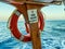 An orange lifebuoy attached to the deck of the ship. rubber protective equipment in case of human flooding. swimming underwater in